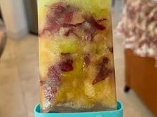 Beating the heat with a home made green and red grape frozen popsicle. 