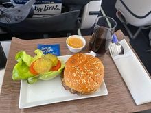 AS 620, SEA-DEN March 13. The burger wa very tasty once the salt and pepper were added. The thin sauce tasted of mayonnaise, ketchup & mustard. A bit sloppy as it fell out of the bun. I like it a lot! My only complaint is how cheap AS has become with their short haul product. Add a bag of Tim's chips and the meal would have been fine for the 2 hour flight.