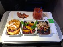 Buttermilk pancakes, maple glazed bacon, fresh fruit, tomato juice, and açaí bowl