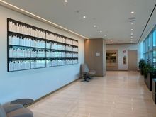 Walkway from lower level entrance to the elevators with tarmac views on one side
