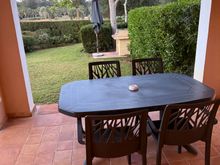 the outdoor area with table and chairs and an outdoor grill