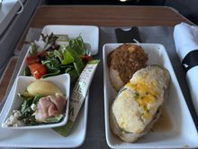 Overcooked chicken served in an imitation St. Hubert poutine gravy (prolly the canned stuff from Couche-Tard) served alongside a flavourless, under-baked potato. The appetiser, which is crumpled up like a one dollar bill, tastes like prosciutto di Parma (and may also be the most expensive thing on this plate). Also, reducing the salad by 50% to plate the appetiser within the salad appears to no longer be a one-off. I wonder how many thousands American Airlines is saving its shareholders.