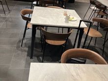 4-person tables in the dining area predominate the space.
