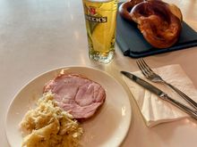 Proper German cuisine. Piece of pig, sauerkraut, brezel, beer.