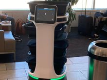 A robot doing circles,  where you could put your used plates / cutleries away