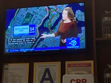 The local news broadcast with traffic report with CC is shown during breakfast at the bar 