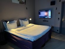 Downstairs with one king bed; there is a small stool next to the television