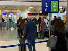 Huge group crowding around one agent trying to "pre-board" as she tells various gate lice why they don't qualify. . . 