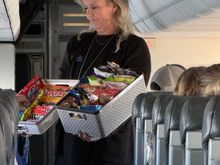 VP of Inflight for DAC (and our F/A that day) with what is the best snack basket in the industry. Flight was full of city and county execs, those of us who helped, etc. 