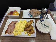 Parmesan-less Parmesan scrambled eggs with legit pea meal bacon and flavourless potatoes. Good fruit plate.