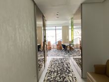 Long entry hallway with a sofa, useful if you feel like sitting next to the door and staring at the wall.