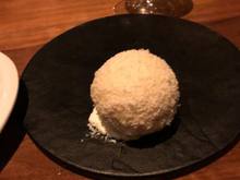 Coconut, while chocolate and almond outer shell enclosing a scoop of ice cream