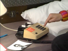 Old phone (and close-up on the analog clock next to the bed)