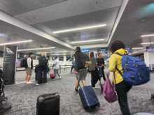 I never understood queue crawlers who line up and end up getting swamped by those with priority boarding when the flight is called. 

We ended up departing 20 min late, but not to worry, I have 5 hours in HNL. 