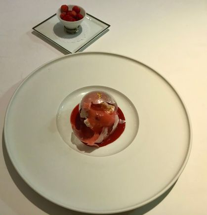 Broken sphere with strawberries within 