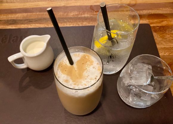 Iced latte with extra milk , iced water with lemon wedges ..