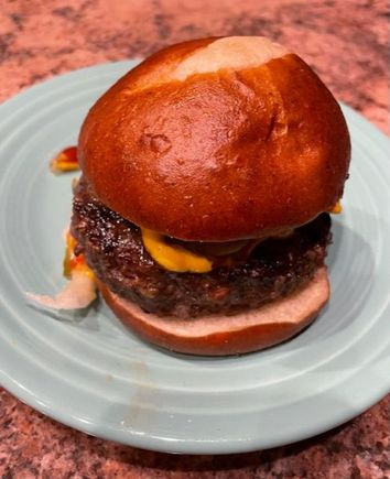 Jalapeño cheddar burger on a pretzel bun. 