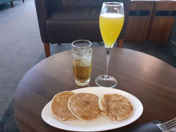 American pancakes with maple syrup, apple juice and Bucks Fizz