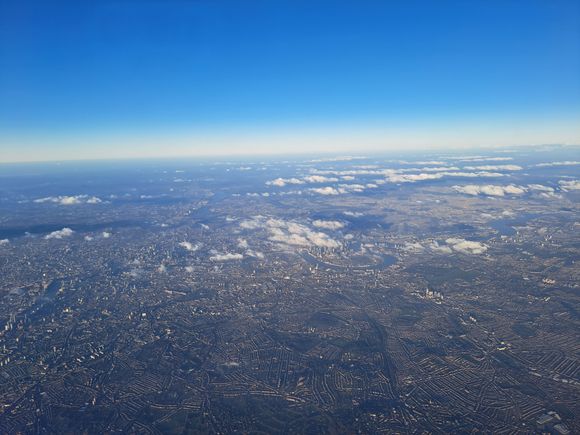 London from  BA700 LHR-VIE 21st Jan . London Eye to the left. 02 arena in the middle a few speckled clouds  over Canary wharf. Beautiful take off views