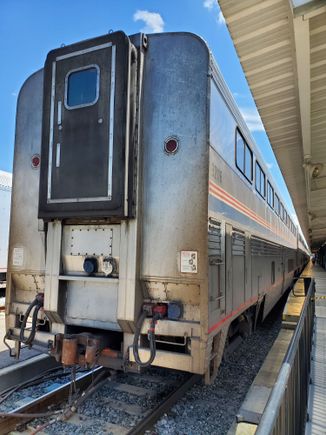 The rear view of one of the pieces of the train that were parked. If I recall correctly, there were two of these, one on either side of the platform structure (I say this because in most countries, they would be counted as two platforms). Each coach was identified by a number and we were instructed which coach was ours (based on the check-in information). As it turned out, this was our very coach. The three coaches here would be attached to the rear of the ones on the platform to the right.