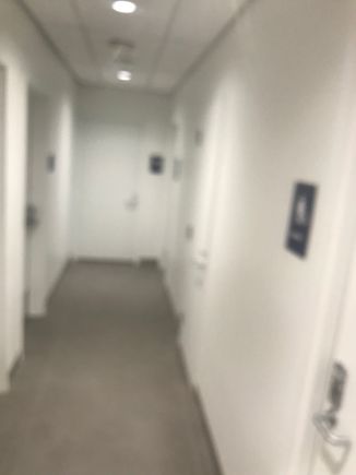 Bathrooms down a sort of industrial hallway