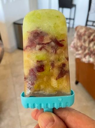 Beating the heat with a home made green and red grape frozen popsicle. 