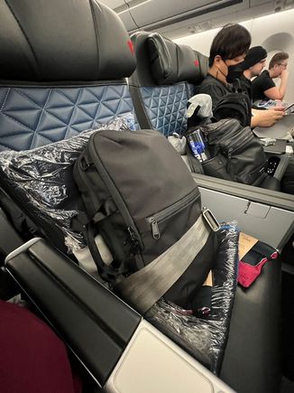 Is two seats/screens/tray tables better than a first class seat?