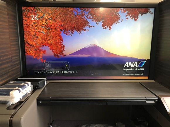 The screen fits the whole width of the suite; it's as large as the ones on Asiana (RIP) and other carriers that give the screen this much space. My breath was literally taken away by the autumn picture they displayed of Mt. Fuji, where I had just come from! I kept the flight map on for most of my flight, and the resolution stayed immaculate throughout.