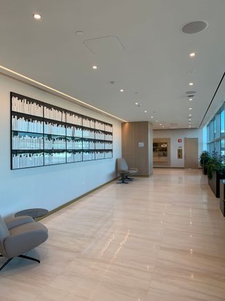 Walkway from lower level entrance to the elevators with tarmac views on one side