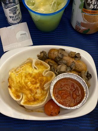 Breakfast on UA219 ORD-HNL 011/28/21:
Close up of entree - Leek quiche with breakfast sausage, potatoes, tomato and tomato sauce