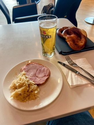Proper German cuisine. Piece of pig, sauerkraut, brezel, beer.