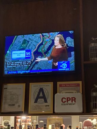 The local news broadcast with traffic report with CC is shown during breakfast at the bar 