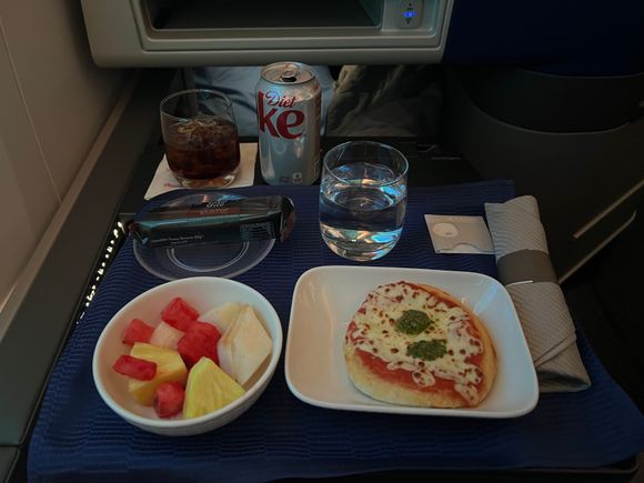 Pizza margherita before landing - tasted like a decent frozen pizza. Wish there was a more substantial meal service though. 