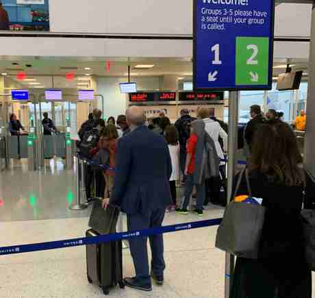 Huge group crowding around one agent trying to "pre-board" as she tells various gate lice why they don't qualify. . . 