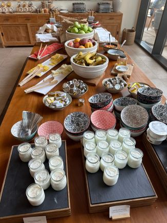 Yogurts, fruits and bread at breakfast