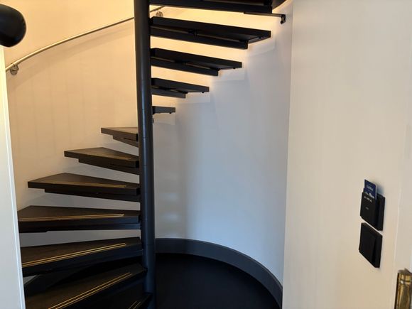 Spiral staircase to upper floor, reception was very attentive to suggest someone would escort us and bring our stuff upstairs