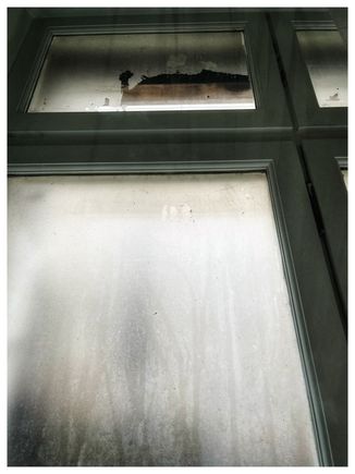 Our bedroom window. The cloudiness is not due to the rain, however, as it was frosted, since the only thing you would have been able to see was the building next door.