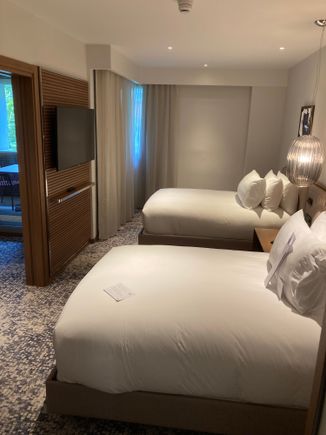 The bedroom has a TV and ample space