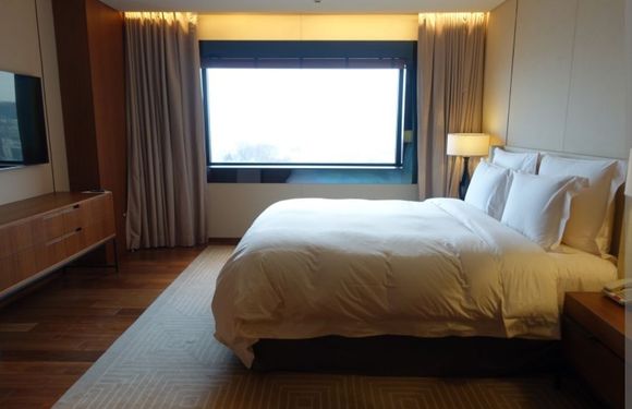 A very plain bedroom like the rest of the suite 