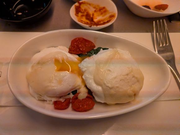 Poached eggs benedict with the runny yolk we just discussed upthread. Everyone in my row and behind me were awake at this point so I opened my window halfway which seemed to confuse the sensor on my phone camera, weird lighting and artifacts as a result. I think I would enjoy this a bit more if the pide base were pre-cut a bit as I made quite a mess cutting it. As mentioned previously I find it rather tough to cut compared to english muffins. Overall very good flavors.