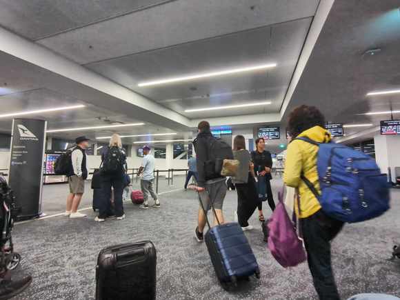 I never understood queue crawlers who line up and end up getting swamped by those with priority boarding when the flight is called. 

We ended up departing 20 min late, but not to worry, I have 5 hours in HNL. 