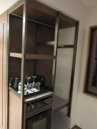 Bar area with Nespresso Machine. Mini-fridge empty during Covid.