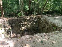 The pit where lime was melted down to make limestone for the construction of the temples and pyramids.  Tikal.