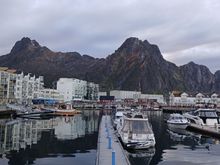 Svolvaer is famous for Svolværgeita, a jagged twin-peaked mountain famous among rock climbers. If you zoom into this photo, and follow the line of blue poles you can see it on the mountain - looks liek two fingers or agoat's horns