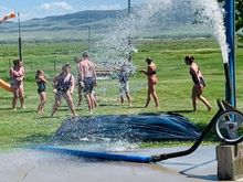 Montana slip n’ slide with the hose hooked up to the water from the irrigation ditch. Some of the grandkids at my in-laws. 