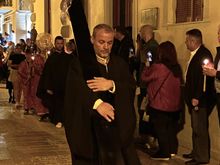 The procession moves through the street