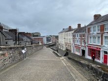 Along the wall on the west side