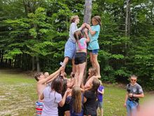 Greased pole climb. Do.lar bills are pasted to the pole with grease. The kids can jump in the river afterwards to get cleaned up. 