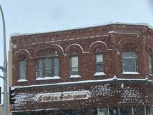 one of our towns origional stores with snow flakes coming down.