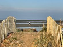 Could it be because I turn around from looking at those houses and I see a guy looking for...whatever out on the beach?